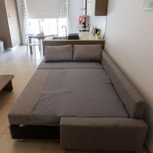 Living room sofa opened out as a bed